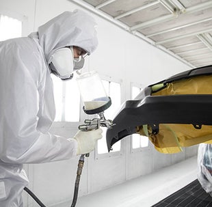 Collision Center Technician Painting a Vehicle | Andy Mohr Toyota in Avon IN